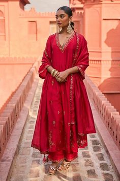 Red kurta with patra embroidery in floral pattern. Paired with a pant with patra embroidered hem and dupatta.
Components: 3
Pattern: Embroidery
Type Of Work: Patra, Floral
Neckline: V Neck
Sleeve Type: Three Quarter Sleeves
Fabric: Silk, Organza Silk
Color: Red
Other Details: 
Floral embroidered border dupatta
Note: The outfit worn by the model at the back is not for sale
Occasion: Mehendi and Haldi - Aza Fashions Red Anarkali, Easy Clothing, Chanderi Dupatta, Red Kurta, Printed Embroidery, Cotton Dupatta, Hand Work Embroidery, Kurta With Pants, Silk Pants