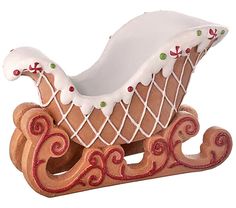 a wooden sleigh with white and red decorations