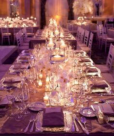 a long table is set with silverware and candles