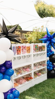 an outdoor party with balloons and decorations