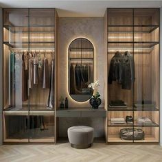 a walk in closet with an oval mirror on the wall