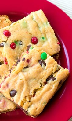 a red plate topped with cookies and candy bars