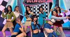 girls'generation perform on stage in front of a checkerboard background with the words,