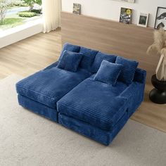 a large blue couch sitting on top of a white rug