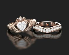 two wedding rings with hearts and diamonds on them, one has a diamond in the middle