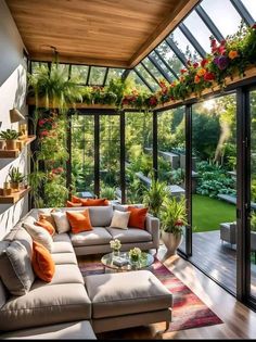 a living room filled with furniture and lots of plants