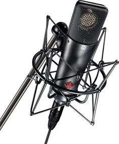 an old fashioned microphone on a stand with a mic attached to the top of it