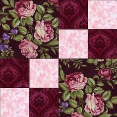 a patchwork quilt with pink and purple flowers on maroon, green and white squares