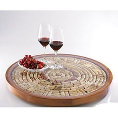 two glasses of wine are sitting on a cork coaster