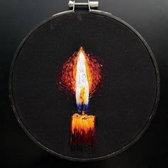 a lit candle is painted on a black background