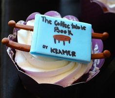 a cupcake with frosting and icing on it that reads the coffee table book by hammer