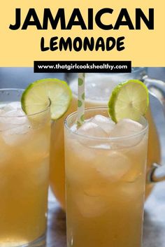 two glasses filled with lemonade sitting on top of a table next to limes