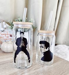 two mason jars with elvis presley images on them, one is empty and the other has straws in it