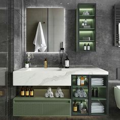 a modern bathroom with marble counter tops and green cabinets, along with white towels on the shelves