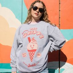 Women's printed sweatshirt with “Mrs Whippy” slogan and vintage style ice cream character graphic. Give it some swirl power in this graphic slogan sweater. Super-comfy oversized fit. Makes a great gift and a sweet self purchase for summer staycation. All Batch1 products are lovingly designed, printed and packed by hand in the UK at Batch1 HQ.  Our garments are made to order to minimise wastage and printed using water-based, eco-friendly inks. We are committed to creating on-trend, environmentall Retro Cotton Sweatshirt With Cartoon Print, Retro Cotton Sweatshirt With Funny Print, Trendy Relaxed Fit Sweatshirt With Cartoon Print, Fun Graphic Print Sweatshirt For Loungewear, Fun Sweatshirt With Funny Print Relaxed Fit, Relaxed Fit Fun Sweatshirt With Funny Print, Relaxed Fit Funny Print Sweatshirt, Ice Cream Character, Ice Cream Graphic