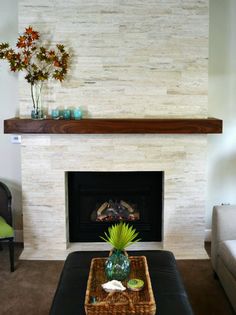 a living room with a couch, coffee table and fireplace