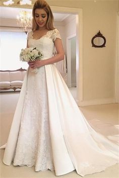 a woman in a white wedding dress holding a bouquet