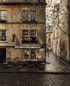 an old building with tables and benches in the courtyard