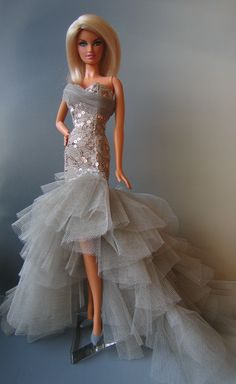 a barbie doll dressed in a silver dress