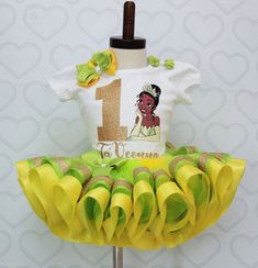 a dress made out of yellow ruffles and a t - shirt with the number one on it