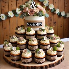 wedding cupcakes are arranged in the shape of a cake