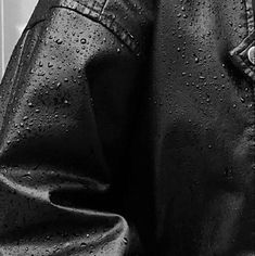 black and white photograph of leather jacket with water droplets on it's lapel