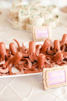 there are many pieces of food on the plate and one is shaped like an octopus