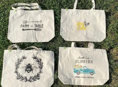 four bags with different designs on them sitting in the grass next to a bag that says farm to table and flowers