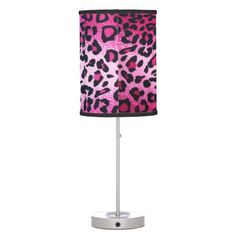 a pink and black leopard print lamp on a white base with a black fabric shade