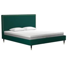 a bed with green headboard and white sheets on it's sides, in front of a white background