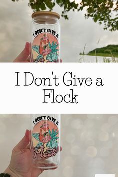 someone holding up a glass bottle with the words i don't give a flock on it