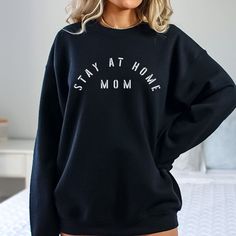 The Stay At Home Mom Crewneck Sweatshirt is perfect for a home maker mama!  I love working with custom orders!  If you have a design in mind, or have something customized already and would like it on a shirt, send me a message and we can make that happen! This item is printed with ink through a partnership with a print company.  It's not one of the hand-painted items in this shop.  Therefore, I have not personally inspected it before it's shipped, or packed with the extra care I give each order. Cozy Black Top With Letter Print, Cotton Crew Neck Tops For Home, Comfortable Letter Print Sweater For Loungewear, Comfortable Relaxed Fit Tops For Home, Comfy Everyday Tops With Letter Print, Comfy Oversized Top With Letter Print, Cozy Oversized Tops With Letter Print, Casual Relaxed Fit Tops For Home, Comfy Tops With Letter Print