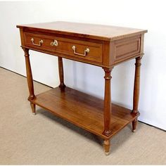 a wooden table with two drawers on it