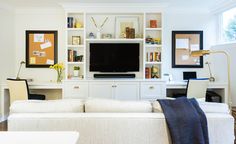 a living room filled with furniture and a flat screen tv on top of a white entertainment center