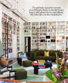 a living room filled with lots of furniture and bookshelves