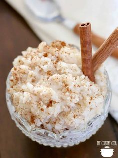 a small glass bowl filled with food and cinnamon sticks