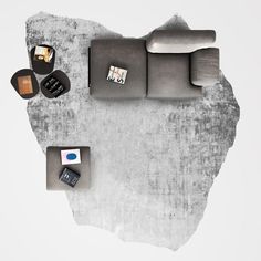 an overhead view of a modern living room with grey furniture and accessories on the floor