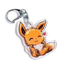 a keychain with an image of a little fox on it's back