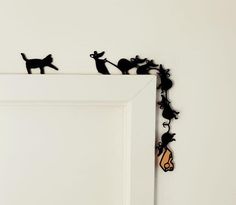 a white door with some black cats on it