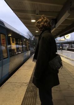 a woman waiting for the train to arrive