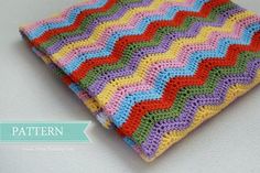 a colorful crocheted blanket sitting on top of a table