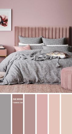 a bedroom with pink walls and grey bedding in shades of gray, beige, and pink