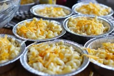 several tin cups filled with macaroni and cheese