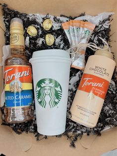 an open box containing starbucks drinks and condiments