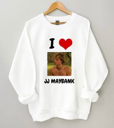 I Heart JJ Maybank Sweatshirt Pogue Friends Sweatshirt, Outer Banks Sweatshirt, John B, Pogue Tees, Outerbanks Fan Gift Shirts, Obx Shirts, Pogue Life Crewneck Sweaters Made of 50% cotton, 50% polyester. All sizes are unisex and true to size. Please order a size up for an oversized fit. Thank you for looking at this listing and shopping with us, please contact us with any questions or concerns but please read full listing details prior ♥ ♥Each item is handmade & made-to-order with love♥ TO CARE FOR YOUR SHIRT 1. Wash Inside Out in Cold Water 2. Hang Dry OR Dry on Low Heat * DO NOT Iron OR Dry Clean Thank you! ♥ I Heart Jj Maybank, Jj Maybank Merch, Obx Merch, Rudy Pankow Aesthetic, Outer Banks Merch, Outer Banks Sweatshirt, Pogue Life Outfits, Jj Obx, Pogue Style