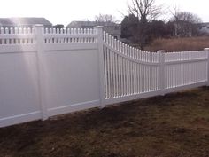 a white fence in the middle of a yard