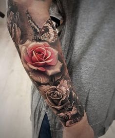 a man's arm with a rose and butterfly tattoo on the left forearm, half sleeve