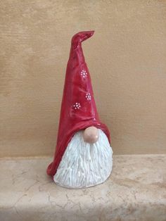 a red and white gnome figurine sitting on a shelf