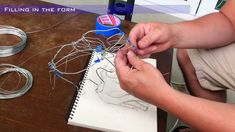 a person is working with wire on a table