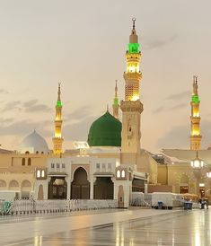 a large white building with green domes and lights